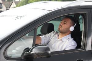 man wearing headphones while driving